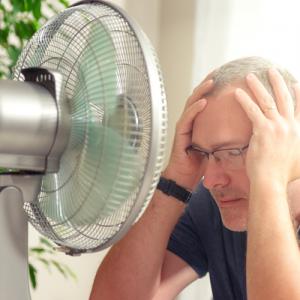 Man in front of a fan