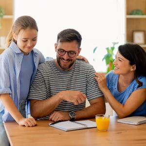 Smiling Family Paying Bills